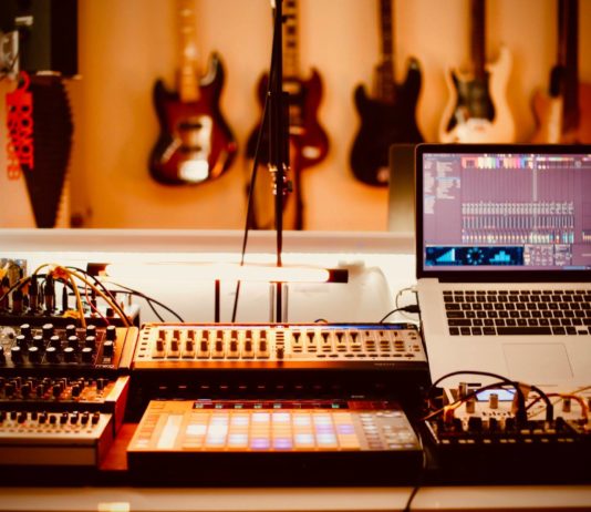 Home Recording Studio with Guitars, Laptop, Midi Controller and Mixer