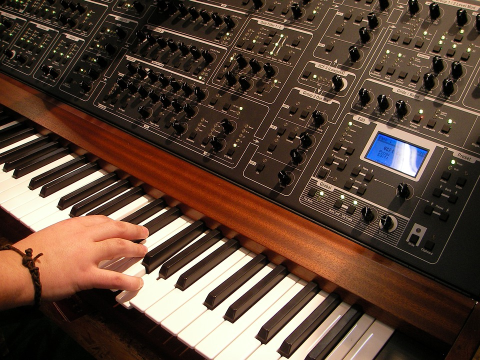 Hand playing synthesizer