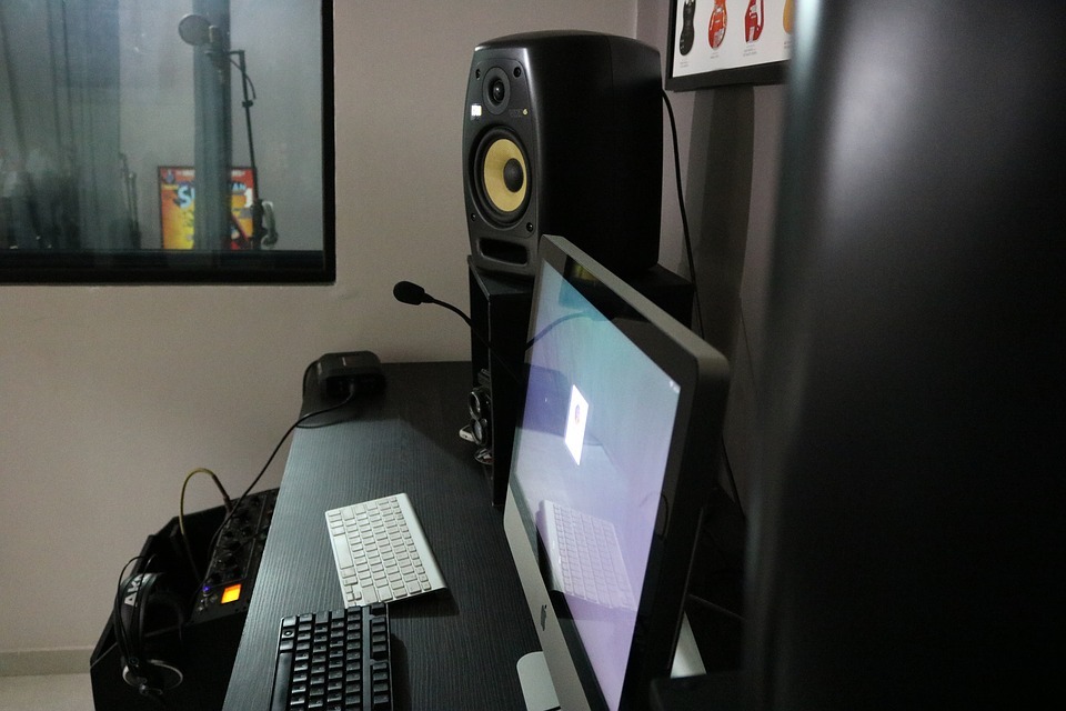 krk studio monitors on home recording studio desk