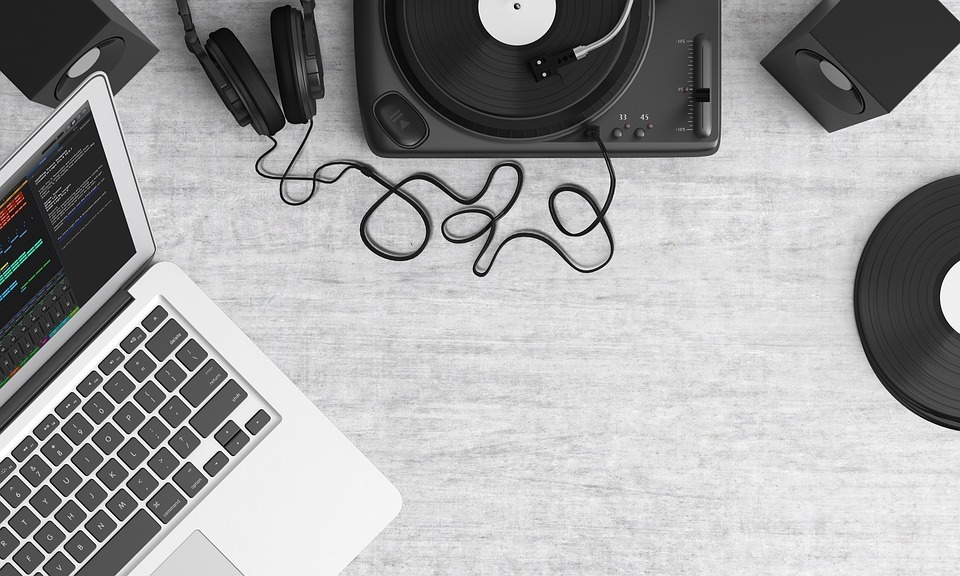 Turntable with laptop and speaker on desk