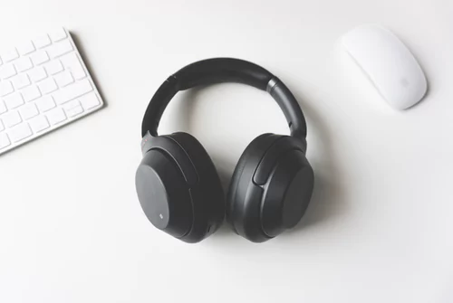 Wireless bluetooth headphones rested on white desk