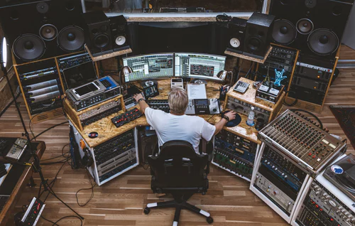 Producer working at recording studio desk