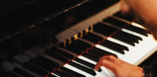 man playing grand piano