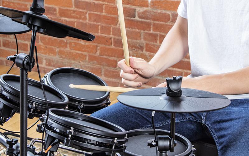 Drummer playing electronic drum set