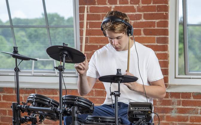 Man Playing Mesh Electronic Drum Kit