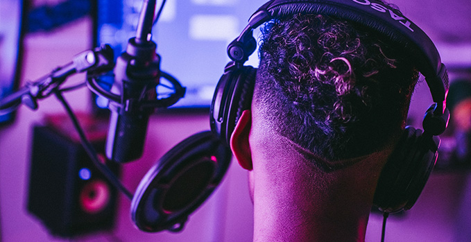 Image of a vocal artist in a studio recording vocals