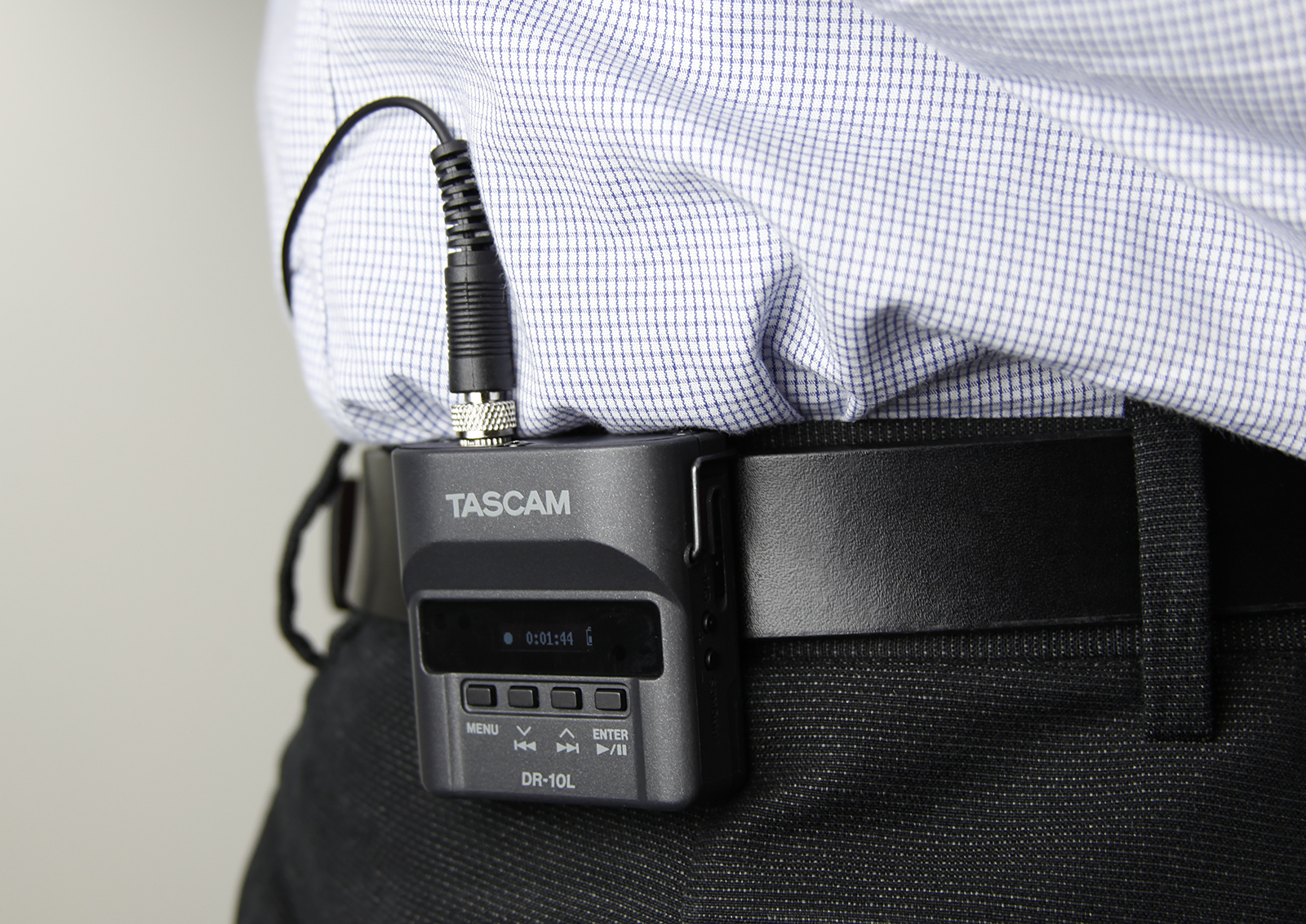 TASCAM DR-10L shown clipped to a mans belt