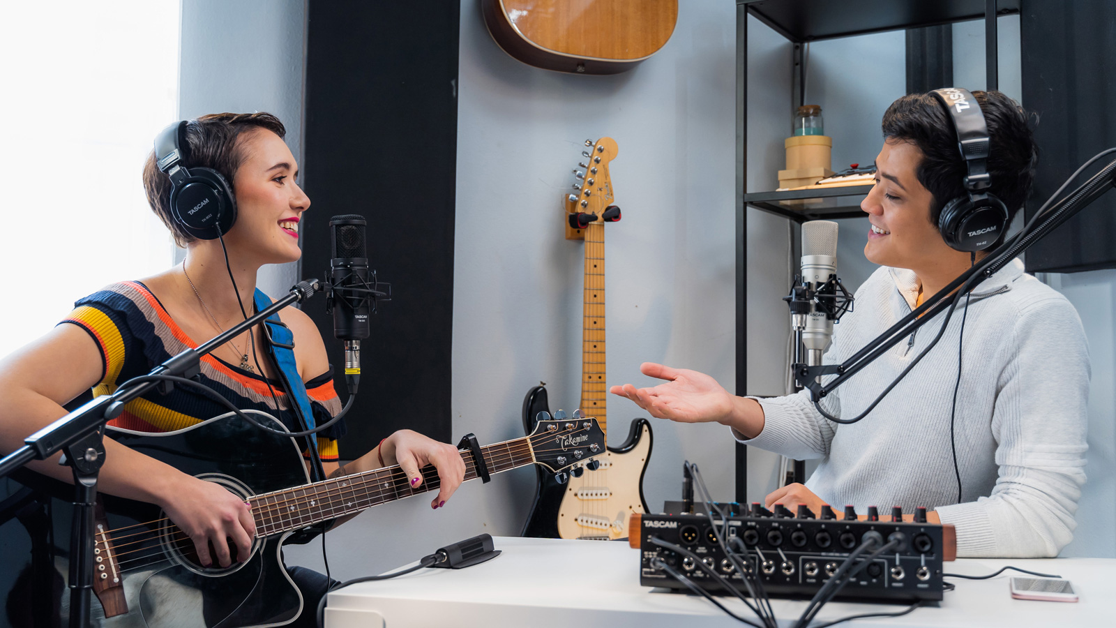 image of guitarist being interviewed with microphones connected to computer via XLR to USB.