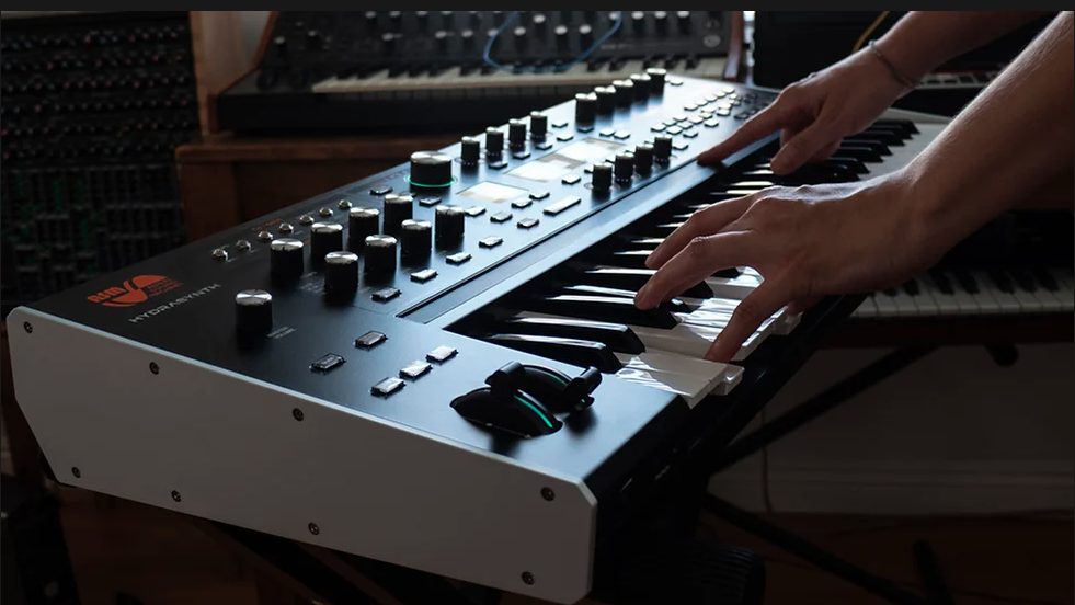 image showing a person playing the ASM Hydrasynth Explorer synthesizer from a different angle