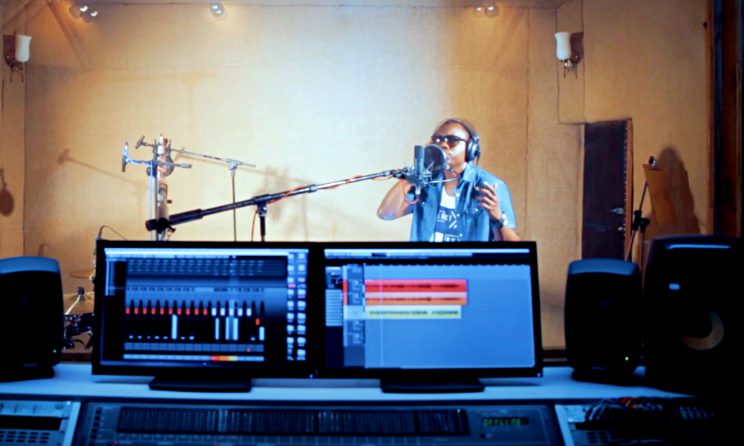 image of home recording studio and man singing into microphone